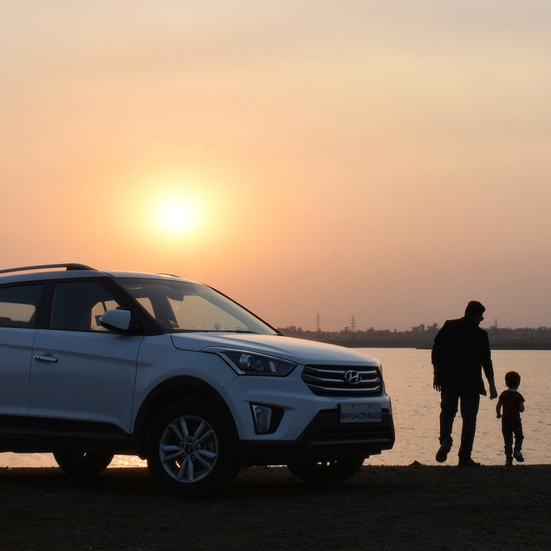 Family on a beach at sunset | Featured Image for the Car Finance Broker Page of FinanceBeagle.