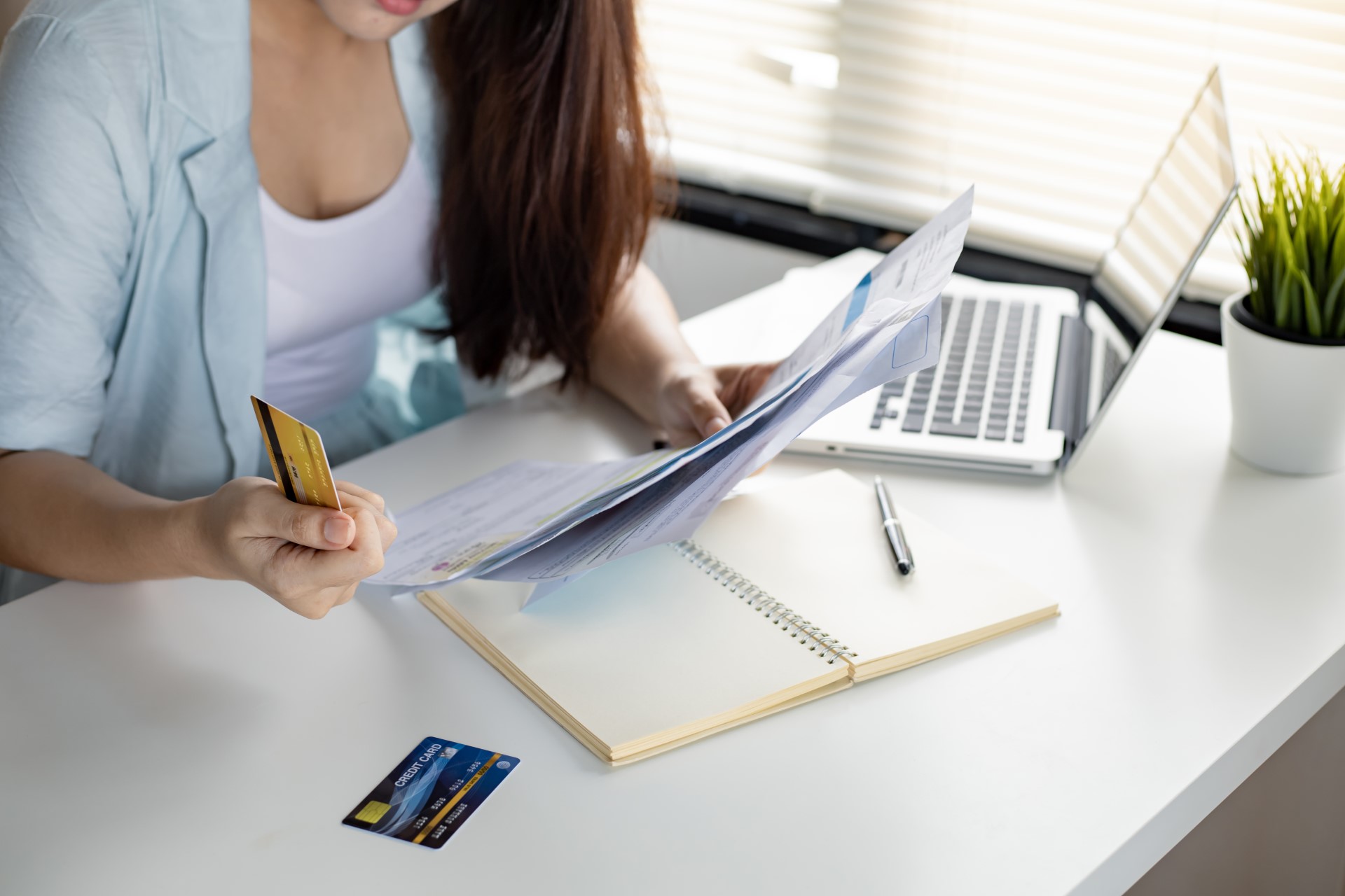 Woman paying off debt | Featured image for Benefits of Debt Consolidation blog.
